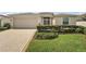 One-story home with beige exterior and landscaping at 27227 Roanoke Dr, Leesburg, FL 34748