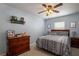 Guest bedroom with dresser and patterned bedding at 7425 Lake Marni Ct, Mount Dora, FL 32757