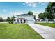 Two-story house with a large front yard, driveway, and attached garage at 7425 Lake Marni Ct, Mount Dora, FL 32757