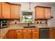 Modern kitchen with granite countertops, stainless steel appliances, and wood cabinets at 7425 Lake Marni Ct, Mount Dora, FL 32757