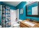 Bathroom with granite vanity and fish-themed shower curtain at 7425 Lake Marni Ct, Mount Dora, FL 32757