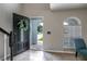 Bright and airy entryway with tile floors and access to the front porch at 7425 Lake Marni Ct, Mount Dora, FL 32757