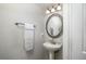 Simple bathroom with pedestal sink and ornate mirror at 7425 Lake Marni Ct, Mount Dora, FL 32757