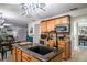Kitchen island with granite countertop and a farmhouse sink at 7425 Lake Marni Ct, Mount Dora, FL 32757