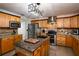 Modern kitchen with granite countertops, stainless steel appliances, and wood cabinets at 7425 Lake Marni Ct, Mount Dora, FL 32757