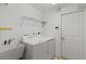 Bright laundry room with washer, dryer, and utility sink at 36649 Sundance Dr, Grand Island, FL 32735