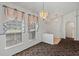 Dining room features neutral walls, carpet, and updated window treatments at 36649 Sundance Dr, Grand Island, FL 32735
