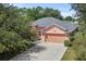 Aerial view of a charming one-story house with a two-car garage at 36649 Sundance Dr, Grand Island, FL 32735
