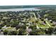 Aerial view of a residential neighborhood near a lake at 36649 Sundance Dr, Grand Island, FL 32735