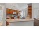Galley style kitchen with wood cabinets, tile floor, and stainless steel sink at 36649 Sundance Dr, Grand Island, FL 32735