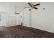 Open concept living area with high ceilings, ceiling fans and carpet at 36649 Sundance Dr, Grand Island, FL 32735