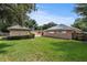 Large backyard with shed, solar panels and green grass at 36649 Sundance Dr, Grand Island, FL 32735