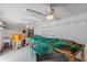 Workshop with workbench, shelves, and ceiling fan at 36649 Sundance Dr, Grand Island, FL 32735