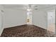Spacious bedroom with ceiling fan and carpet flooring at 36649 Sundance Dr, Grand Island, FL 32735