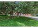 Charming one-story house with a large oak tree and spacious lawn at 36649 Sundance Dr, Grand Island, FL 32735