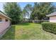 Fenced backyard with green grass and mature trees at 36649 Sundance Dr, Grand Island, FL 32735