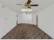 Large bonus room with neutral carpeting and two ceiling fans at 36649 Sundance Dr, Grand Island, FL 32735