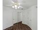 Bedroom with ceiling fan and double door closets at 36649 Sundance Dr, Grand Island, FL 32735