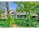 House with lush backyard landscaping and screened porch at 1500 Cobble Ln, Mount Dora, FL 32757