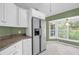 Spacious kitchen with white cabinets, stainless steel appliances, and granite countertops at 1500 Cobble Ln, Mount Dora, FL 32757