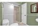 Clean bathroom with shower, toilet, and white tile at 1500 Cobble Ln, Mount Dora, FL 32757