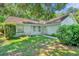 Single-story house with white exterior, green lawn, and mature trees at 1500 Cobble Ln, Mount Dora, FL 32757