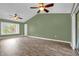 Open living room with vaulted ceiling, wood-look floors and ceiling fans at 1500 Cobble Ln, Mount Dora, FL 32757