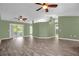 Living room with high ceilings, wood floors and two ceiling fans at 1500 Cobble Ln, Mount Dora, FL 32757