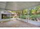 Spacious screened porch with tiled floor and lush backyard views at 1500 Cobble Ln, Mount Dora, FL 32757