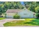 Single story home with attached garage and grassy yard at 1500 Cobble Ln, Mount Dora, FL 32757