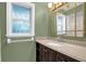 Bathroom with vanity, mirror, and window at 1500 Cobble Ln, Mount Dora, FL 32757