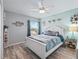 Light and airy bedroom with white bed frame and ceiling fan at 3119 Carrollton Ct, The Villages, FL 32162