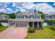 Two-story house with gray siding, blue shutters, and a brick driveway at 2186 Swinstead Dr, Sanford, FL 32773