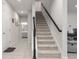 Elegant staircase with a modern black handrail at 2186 Swinstead Dr, Sanford, FL 32773