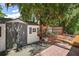 Gray storage shed with a red brick patio and lush landscaping at 507 Lakeshore Dr, Eustis, FL 32726