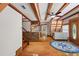 Living area with hardwood floors, staircase and nautical rug at 507 Lakeshore Dr, Eustis, FL 32726
