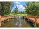 Serene pond with a fountain, wooden bridges, and lush landscaping at 507 Lakeshore Dr, Eustis, FL 32726