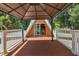 Deck with pergola providing access to the interior of the house at 507 Lakeshore Dr, Eustis, FL 32726