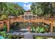 Two story house with a deck over a pond and fountain at 507 Lakeshore Dr, Eustis, FL 32726