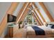 Main bedroom with A-frame ceiling, featuring a king-size bed and dresser at 507 Lakeshore Dr, Eustis, FL 32726