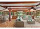 Sunroom with wicker furniture, hardwood floors, and access to the backyard at 507 Lakeshore Dr, Eustis, FL 32726