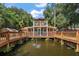 Two story house situated over a pond with a fountain at 507 Lakeshore Dr, Eustis, FL 32726