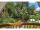 Elevated view of a lush, secluded backyard with a circular bench and palm trees at 507 Lakeshore Dr, Eustis, FL 32726