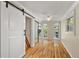 Charming bedroom with hardwood floors and sliding barn door at 507 Lakeshore Dr, Eustis, FL 32726