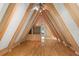 Open loft featuring built-in shelving and hardwood floors at 507 Lakeshore Dr, Eustis, FL 32726