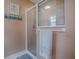 Bathroom with a glass shower enclosure and neutral color scheme at 616 Cokesbury Dr, The Villages, FL 32162