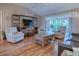 Relaxing living room with comfortable seating and hardwood floors at 616 Cokesbury Dr, The Villages, FL 32162