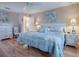 Spacious bedroom with a king-size bed, light wood furniture, and wood flooring at 616 Cokesbury Dr, The Villages, FL 32162
