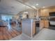 Open kitchen features granite countertops and wood cabinets at 616 Cokesbury Dr, The Villages, FL 32162