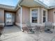 Inviting front patio with seating area, perfect for relaxing at 616 Cokesbury Dr, The Villages, FL 32162